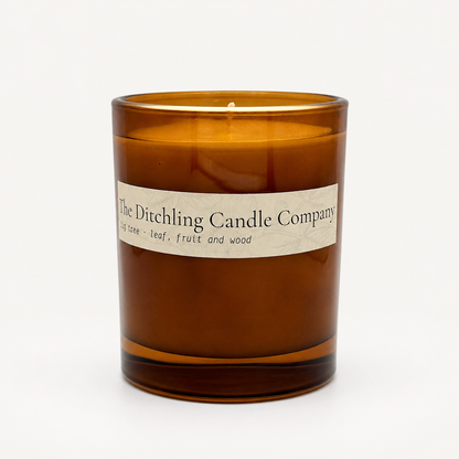 Amber glass fig tree scented soy candle by The Ditchling Candle Company, shown open on a clean white background.